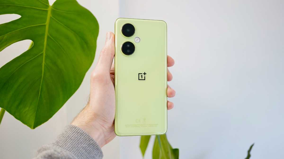 OnePlus Nord CE 3 Lite 5G in hand next to plant