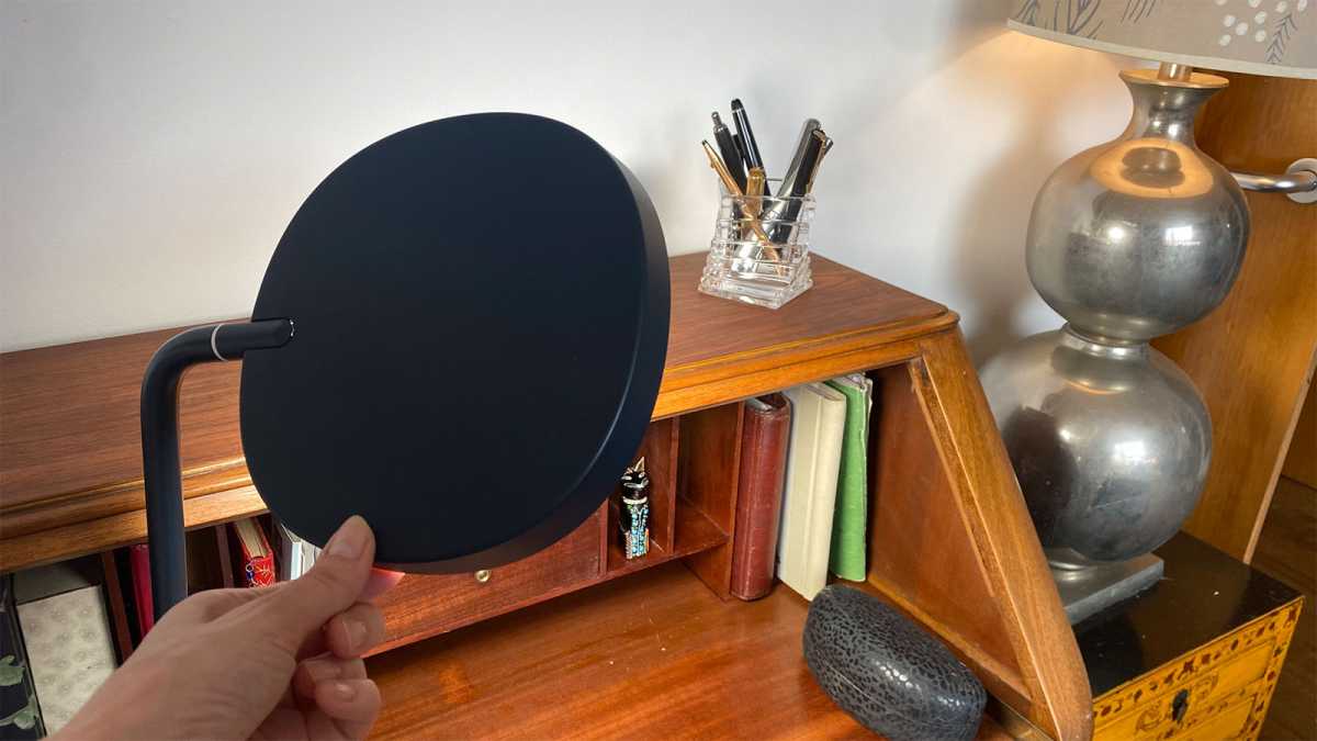 A hand adjusting the angle of the Lumie Task